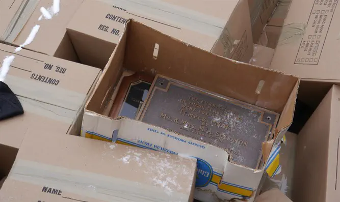 A hole at the cemetery was lined with cardboard boxes containing yahrtzeit plaques, tallit prayer shawls and other ritual items from the once vibrant synagogues in New Castle that merged to form Hadar Israel.