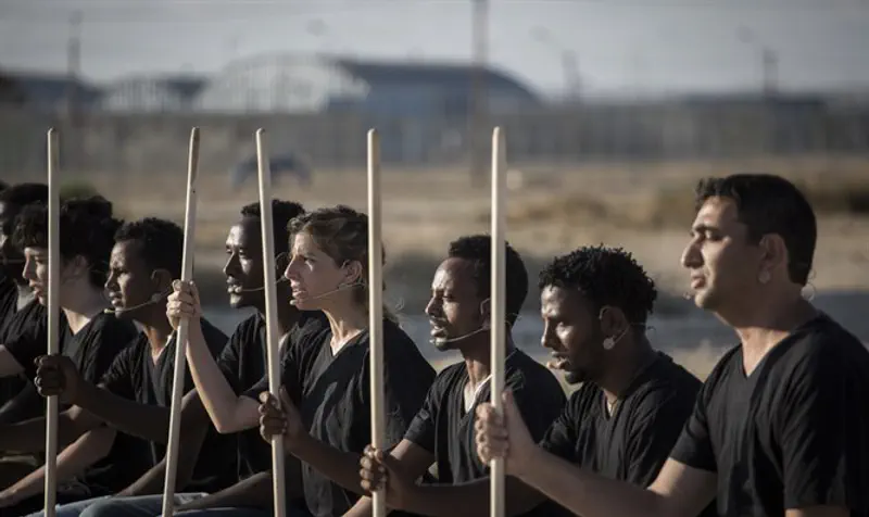 Israeli actors and African detainees participate in play outside Holot detention center