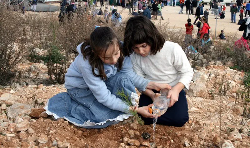 Girls planting trees on Tu B'Shvat