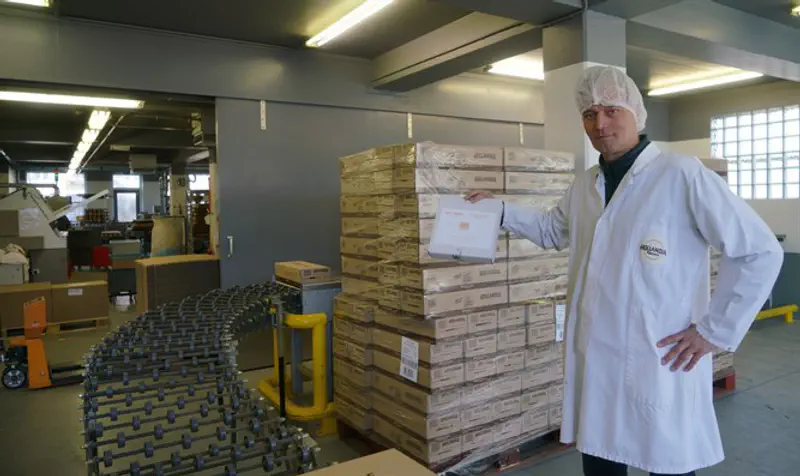 Pieter Heijs displays a box of his product at his Hollandia Matzes factory in Enschede.