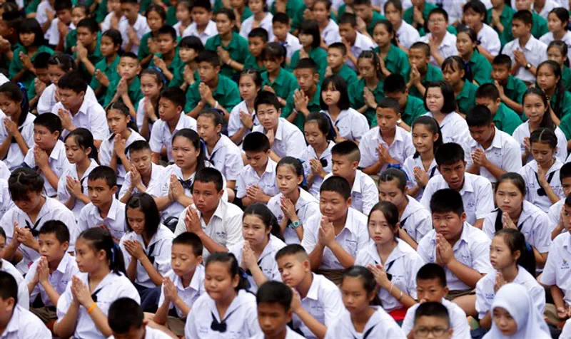 Students pray in Mae Sai Prasitsart school as an ongoing search for soccer team