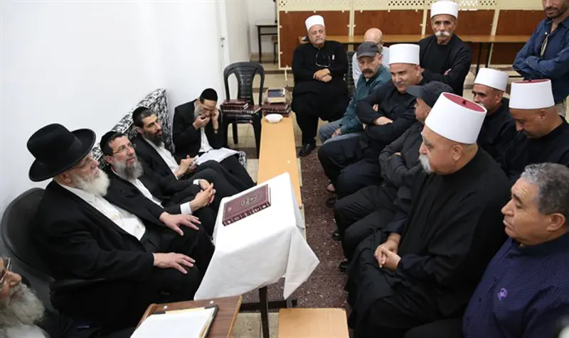 Druze leaders pay respects to Rabbi Shalom Cohen as he sits shiva for his wife
