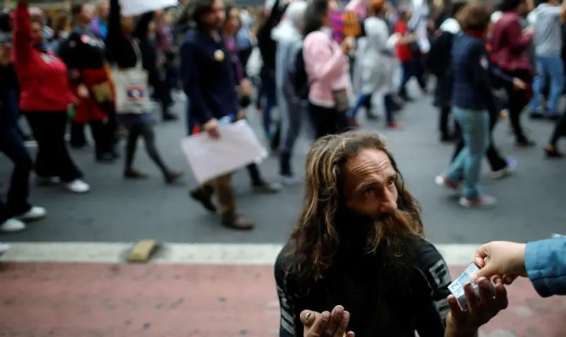 Homeless man gets money during protest in Brazil