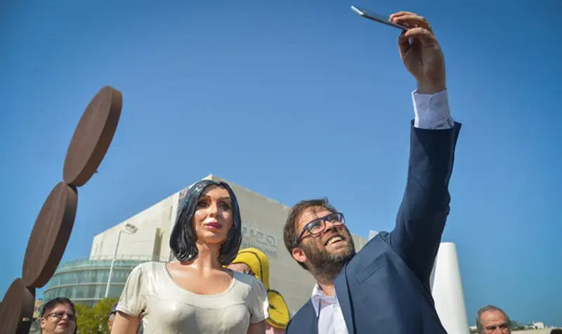 Hazan poses for selfie with statue of Culture Minister Miri Regev