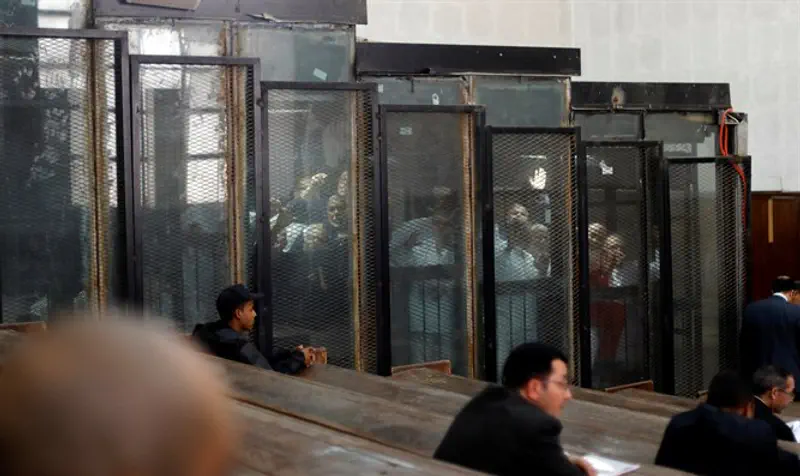 Muslim Brotherhood members behind bars during court session in Cairo