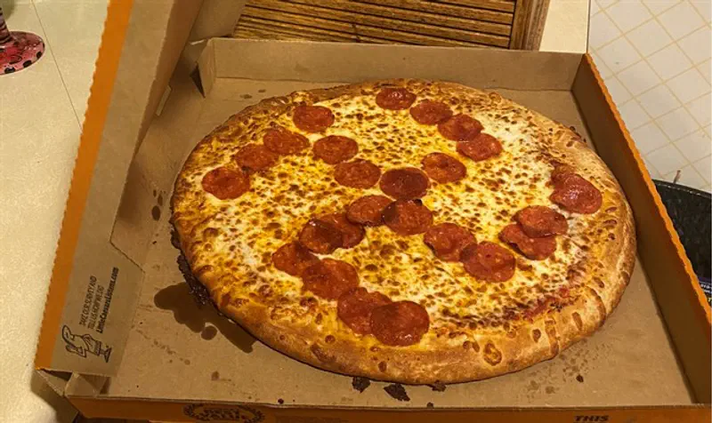 Pizza with pepperonis arranged in the shape of a swastika