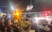 Attack victim passes through Huwara with Israeli flags