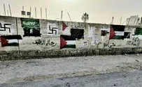 Swastikas and PLO flags on a wall in Huwara
