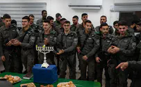 Haredi Border Police officers light the menorah