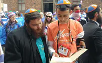 Watch: Chabad offers Tefillin to marchers in Auschwitz