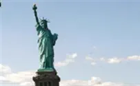 Demonstrator scales Statue of Liberty