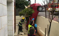 Woman tries to park - and lands on a porch