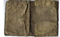 Holocaust-era wallet sewn from Torah scroll discovered in Poland