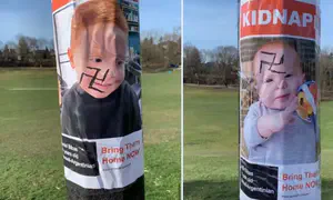 Posters depicting children hostages defaced with swastikas