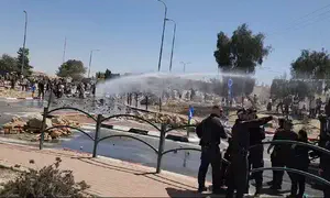 Police use water canons against activists blocking aid trucks