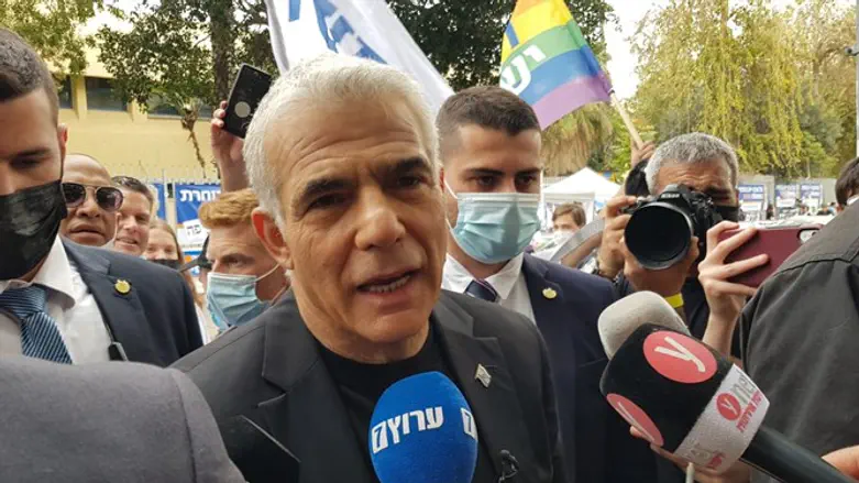 Yair Lapid at entrance to voting station