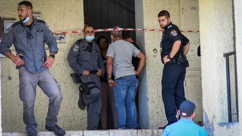 Police at the scene where a woman was found dead in her apartment in Haifa