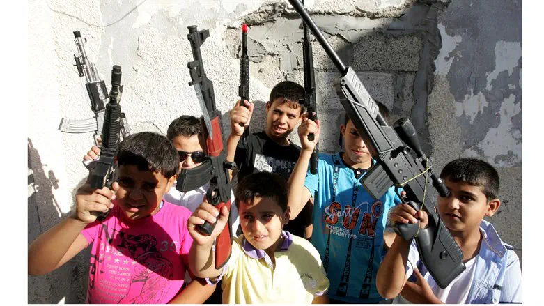 Palestinian Arab children play with toy guns