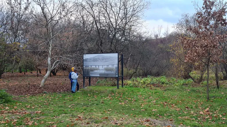 Visitors examine signs at to the former grounds of the Plaszow concentration cam