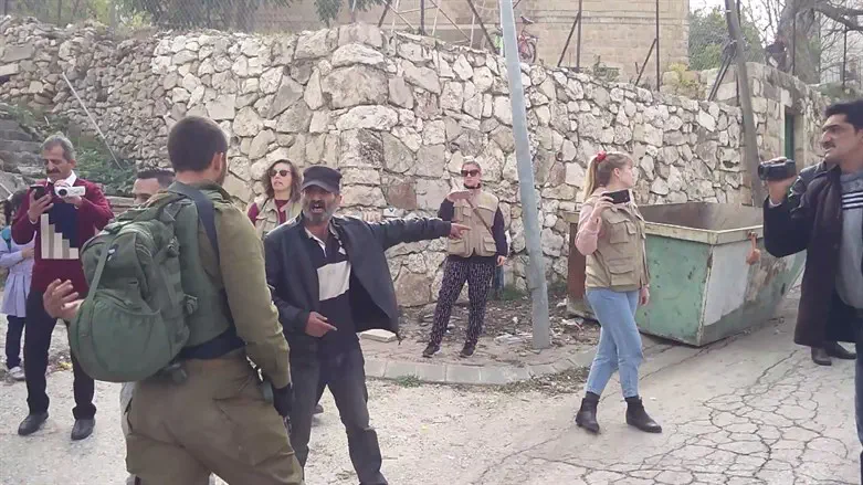 Palestinian provoking IDF soldier while anti-Israel activists film the interaction