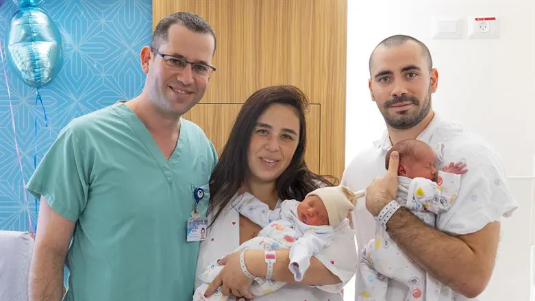 The happy parents, healthy twins, and their doctor
