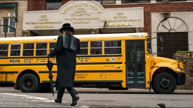 A man walks past the Yeshiva Kehilath Yakov School in South Williamsburg