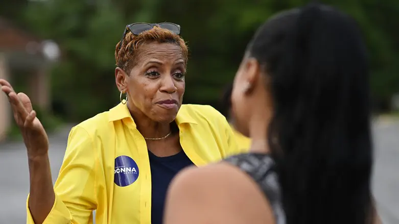 Donna Edwards greets a voter at Breath of Life Seventh-day Adventist Church
