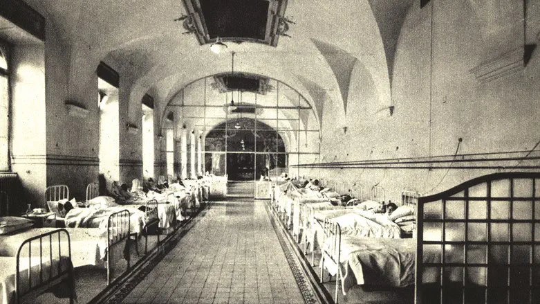 Patients lay in beds in the "Syndrome K" unit at Fatebenefratelli Hospital. 