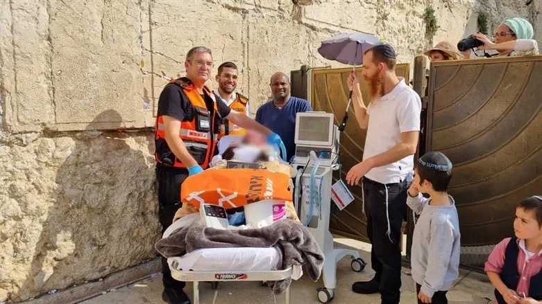 Yosef Yitzchak at the Western Wall with United Hatzalah medical personnel, a nur