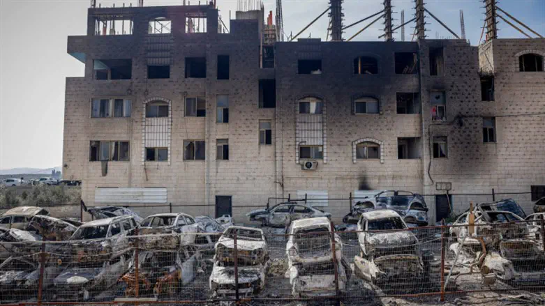 Torched cars in a scrap-yard, and building in Huwara, February 27th, 2023