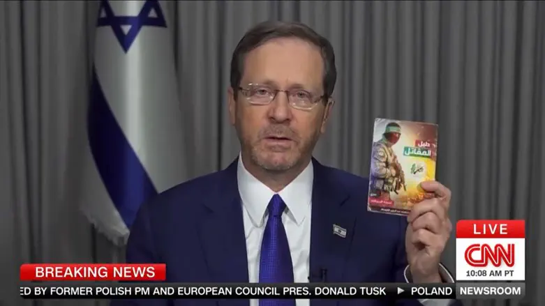 President Isaac Herzog diplays the handbook