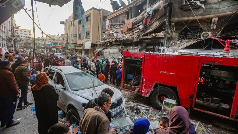 Gazans looking at wrecked homes
