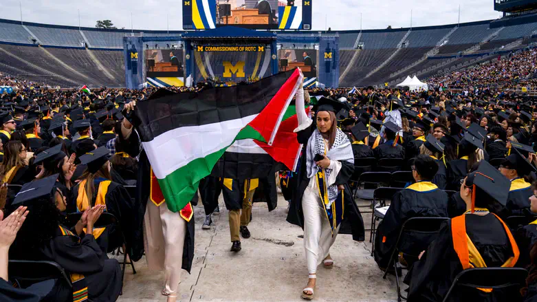 Salma Hamamy with a Palestinian Authority flag at U of Michigan 2024 commencement ceremony