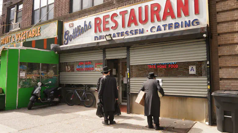 Passersby read notices for the funeral of the owner of Gottlieb's Restaurant, Williamsburg