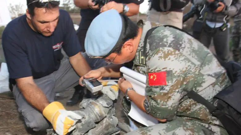 UNIFIL and IDF soldiers check rocket fired from Lebanon