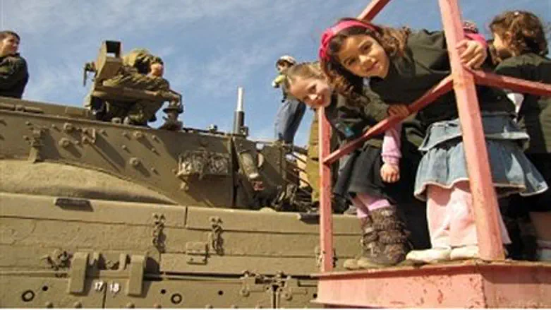 Children look at tanks