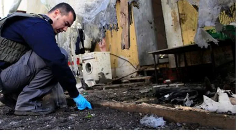 Examining mortar damage in Sha'ar HaNegev (ar