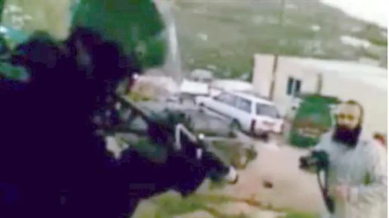 Policeman aims before firing at Havat Gilad.