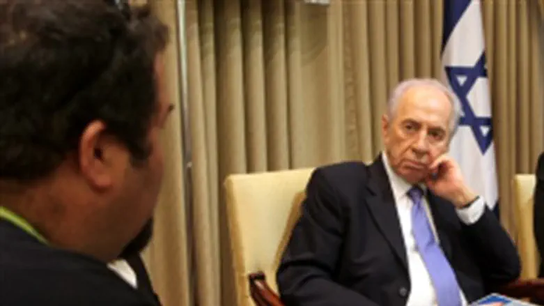Peres listens to terror victim's father.
