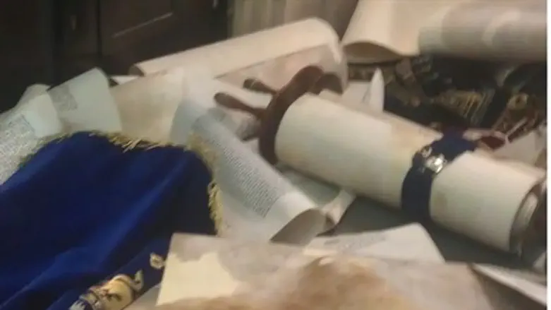 Torah scrolls thrown on the floor in Hemed