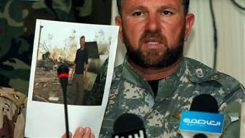 Libya militia commander hold picture of alleg
