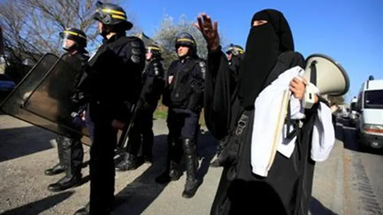  Veiled Muslim protests police raid on terror
