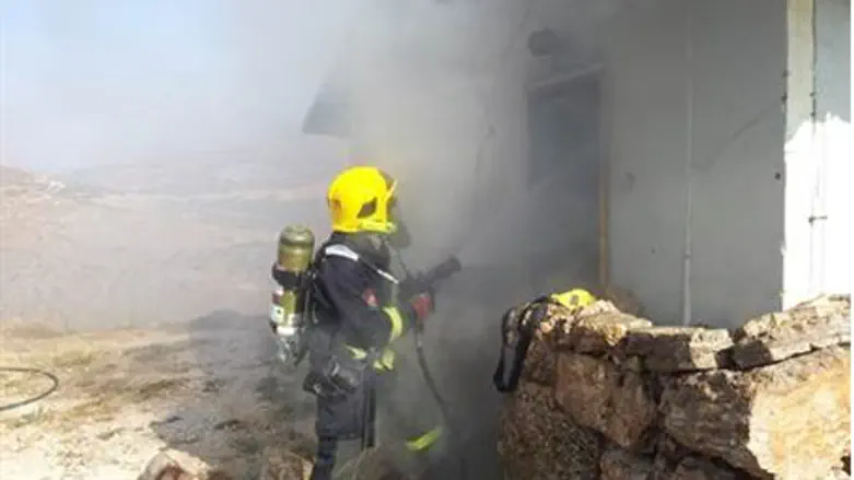 A firefighter battles a blaze
