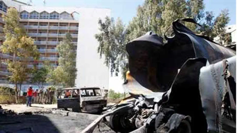 Burnt vehicles are seen after a bomb exploded