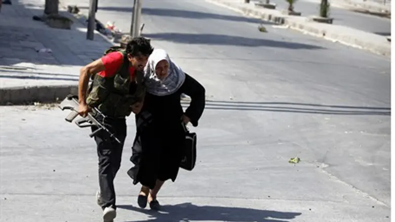 Free Syrian Army fighter helps old woman cros