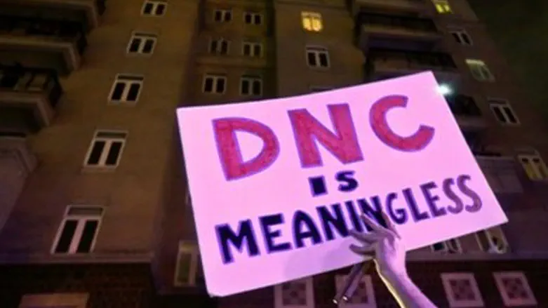 A demonstrator holds a sign outside the Democ