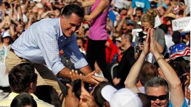 Mitt Romney greets the audience at a campaign