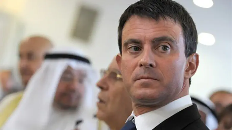 France's Interior Minister Valls stands on a 