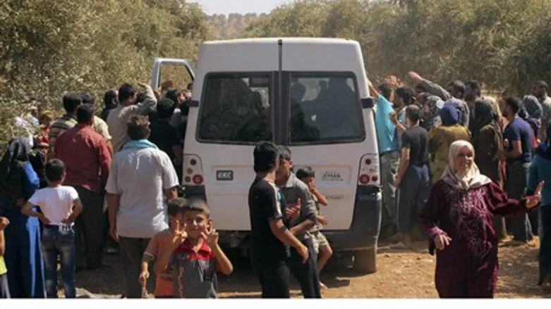 Syrian refugees receive food rations near Tur