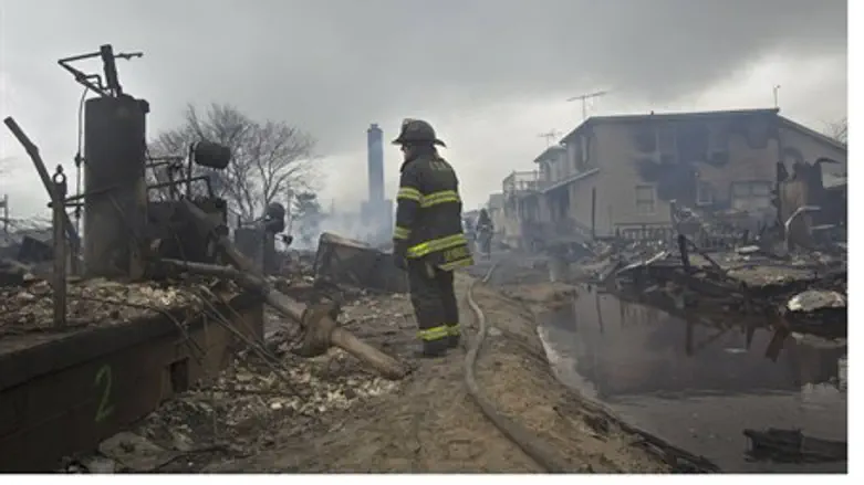 Firefighter stands in Breezy Point after Hurr